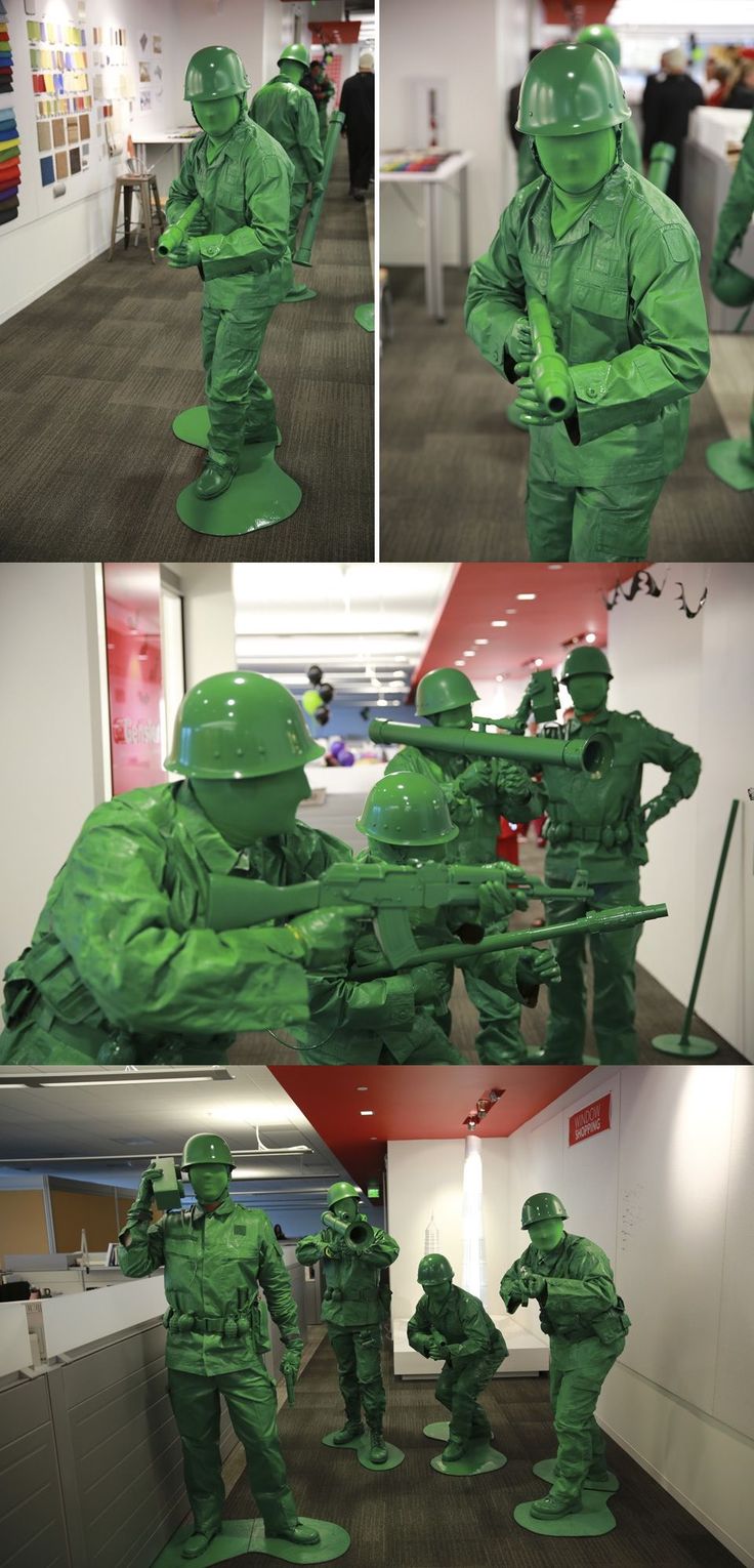 some green plastic soldiers are in the middle of an office building and one is pointing at something