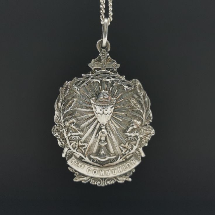 "A magnificent antique Catholic Communion medal, Art Nouveau period French religious holy medal, hallmarked, blank on reverse, in good used condition. A fairly rare religious holy medal, nice size, ideal for protection necklace, would make a nice gift for someone special! Floats from a 22 inch long 925 silver chain! Material: solid silver, hallmarked total weight: 10.5g Measures: approx 26 x 37 mm (1 x 1.5\" inch) A stunning religious shop well worth a visit ... https://etsy.me/2HAqjdY" Commemorative Coin Pendant, Engraved Coin-shaped Spiritual Jewelry And Charms, Miraculous Medal Medallion For Commemoration, Miraculous Medal Medallion Necklaces For Commemoration, Miraculous Medal Medallion Necklace For Commemoration, Engraved Spiritual Medallion Jewelry, Engraved Round Pendant For Commemoration, Spiritual Engraved Medallion Locket Necklace, Engraved Cross Pendant For Commemoration