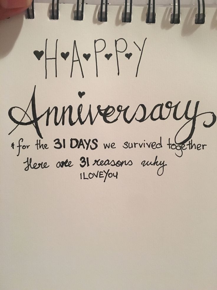 someone is writing on a note that says happy anniversary for the 31 days we survived together