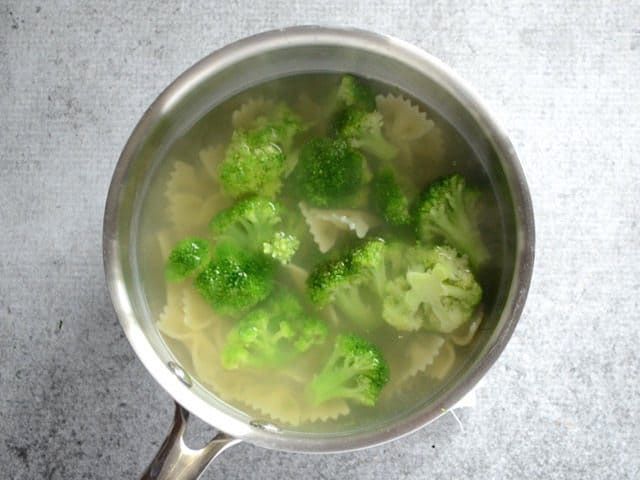 broccoli florets are being cooked in a pot