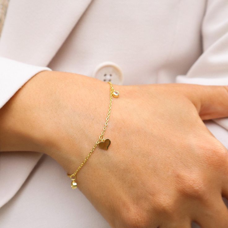 14K Gold-Plated Silver Bracelet with Elegant Heart Charms - A Timeless Expression of Love. 💖 Celebrate Love with Every Wrist Flick 💖 Introducing our exquisite 14K gold-plated silver bracelet, adorned with delicate heart charms. This bracelet isn't just an accessory; it's a symbol of love, affection, and the timeless bonds we share. Why You'll Adore This Bracelet: Elegant Heart Charms: Each heart charm is a reminder of love's enduring presence in our lives. Luxurious Craftsmanship: Crafted from Metal Charm Bracelet With Heart Charm For Mother's Day, Mother's Day Metal Charm Bracelet With Heart Charm, Mother’s Day Metal Charm Bracelet With Heart Charm, Delicate Adjustable Heart Bracelet For Anniversary, Dainty Heart Charm Bracelet For Wedding, Delicate Heart Bracelet With Heart Charm For Mother's Day, Dainty Jubilee Charm Bracelet For Anniversary, Adjustable Dainty Gold Bracelet With Heart Charm, Dainty Chain Bracelet With Charms For Gift