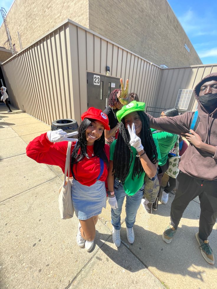 three people in costumes posing for a photo on the sidewalk with their arms around each other