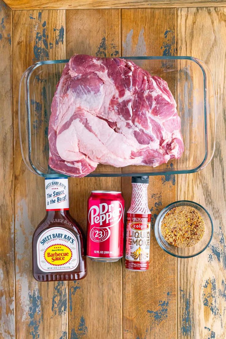 raw meat, seasoning and spices on a wooden table