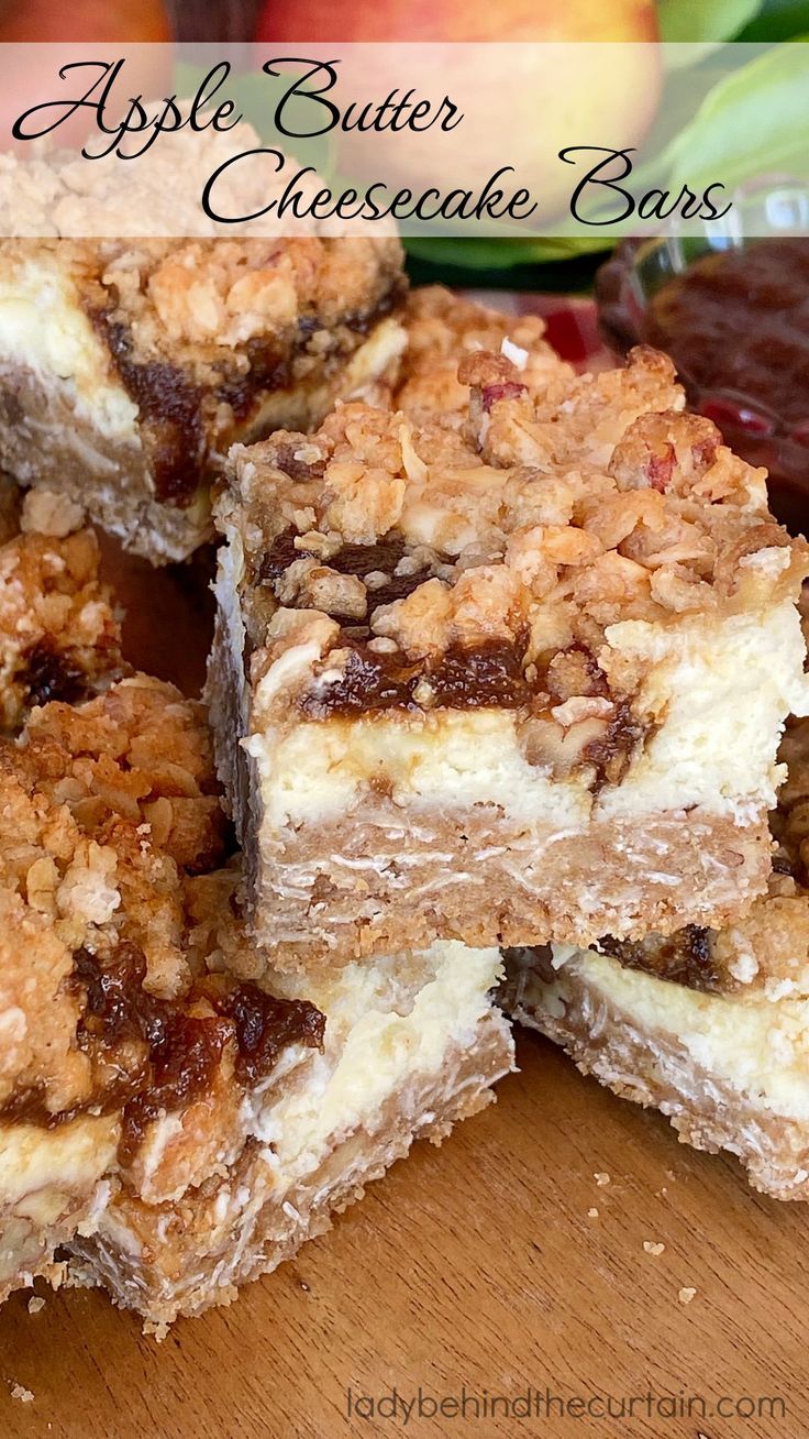 several pieces of dessert sitting on top of a wooden cutting board next to some fruit