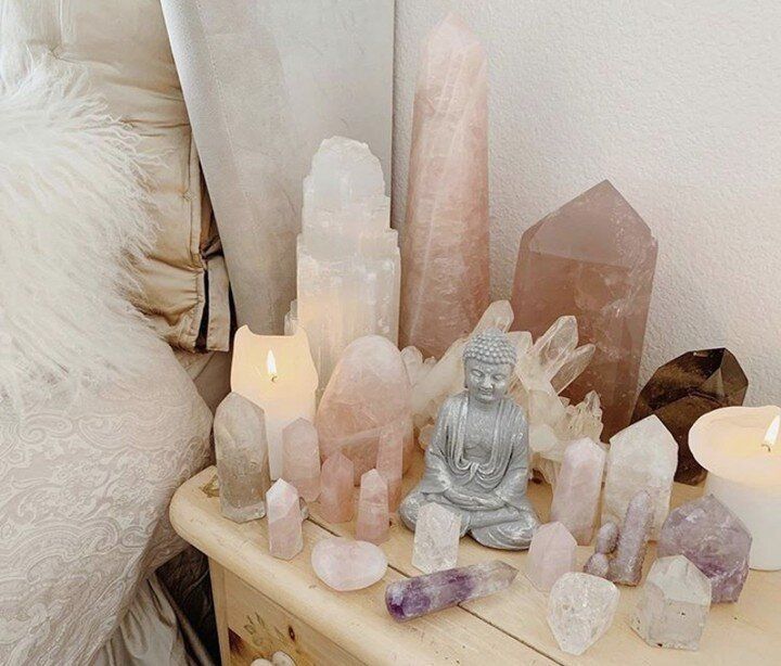 a table topped with lots of different types of rocks and candles on top of it