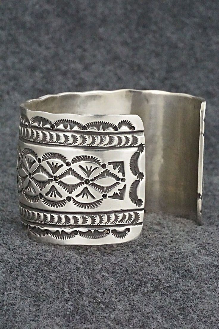 This stunning sterling silver bracelet was made by Navajo silversmith Leonard Maloney. The back is signed Maloney and stamped sterling.Size: 6" (will fit up to a 6 3/8" wrist)Gap: 1 3/8"Width: 1 3/4"Free shipping on all orders! We ship with USPS and always include tracking. All orders ship within a day of payment.Returns are accepted up to 30 days after you receive your order. Just send us a message. Our shop offers cash back or store credit. The item must be returned in new condition. Southwestern Engraved Sterling Silver Bracelet Gift, Silver Untreated Cuff Bracelet Gift, Engraved Sterling Silver Bracelet Gift, Southwestern Silver Cuff Bracelet, Silver Artisan Bracelet, Artisan Sterling Silver Bracelet, Bohemian Sterling Silver Engraved Bracelet, Engraved Sterling Silver Bohemian Bracelet, Untreated Sterling Silver Bracelet