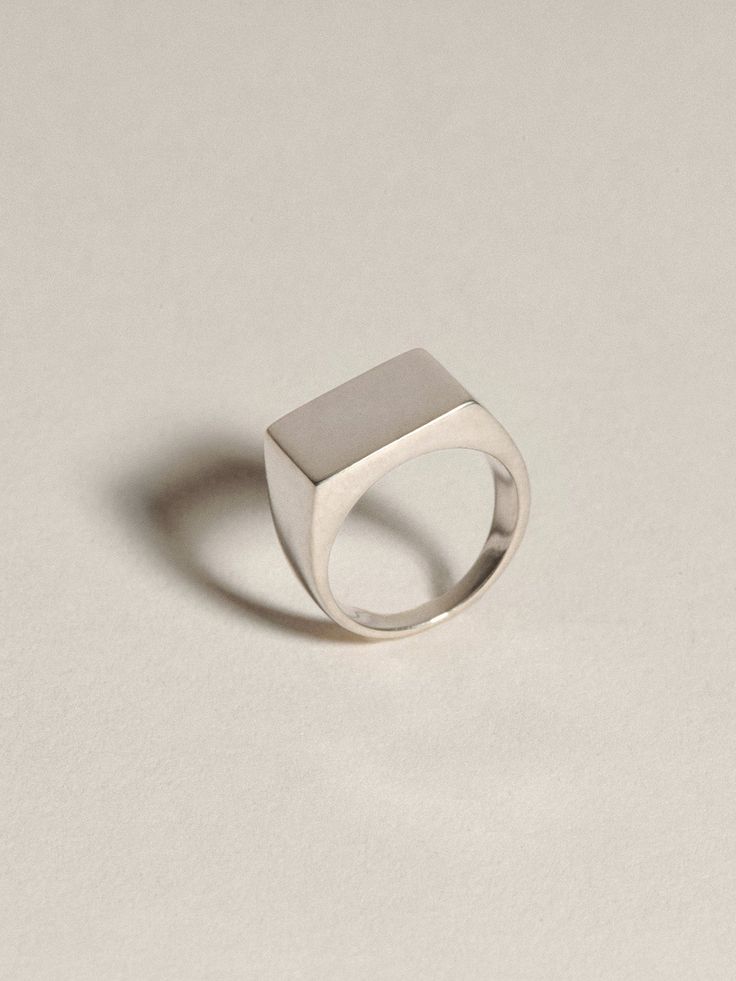 Historically, signet jewelry represented a physical marker of identity — used like a stamp to mark documents or add a seal of significance. Our Signet Collection is a modern re-envisioning of the idea, utilizing recycled gold and silver in the expression of classic forms, each with the option of engraving with a small, personally significant letter or detail.Our classic, unisex Rectangle Signet is a modern heirloom designed for daily wear; the ring your grandfather wore, elevated through materia Modern 14k Gold Signet Ring, Modern White Gold Rectangular Signet Ring, Minimalist Ring With Polished Edges, Classic Rectangular Everyday Jewelry, Minimalist White Gold Rectangular Signet Ring, Modern Sterling Silver Signet Ring With Polished Edges, Classic Sterling Silver Jewelry With Timeless Design, Classic Rectangular Jewelry For Everyday, White Gold Rectangular Signet Ring For Formal Occasions