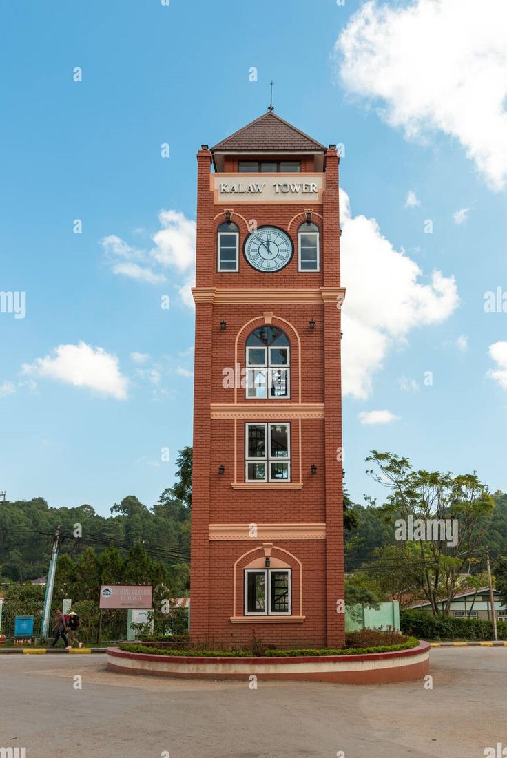 a clock tower in the middle of a parking lot - stock image