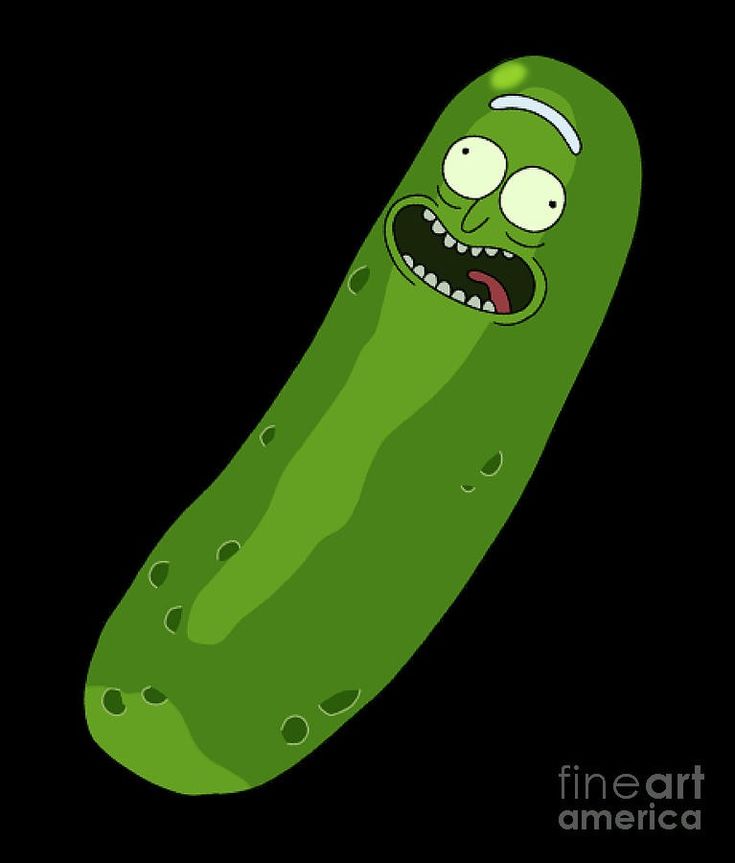 a green pickle with eyes and mouth drawn on it's side, in the dark