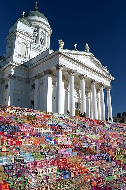 there is a very large building that has many items on the ground in front of it