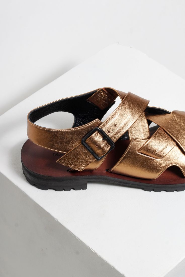 Elevate your style with our luxurious Martina Gold Sandals. The high-low design and strappy antique gold upper make it a statement piece, while the modern black buckle adds a touch of contemporary elegance. Hand crafted with a combination of rubber and leather soles, these sandals offer both comfort and style. Unsure about your size? Please refer to our sizing page or send us a message using the chat button on our website. We will answer straight away. Story London, Chunky Sandals, Gold Sandals, Sandals For Sale, Shoe Sale, E Design, Antique Gold, High & Low, The Modern