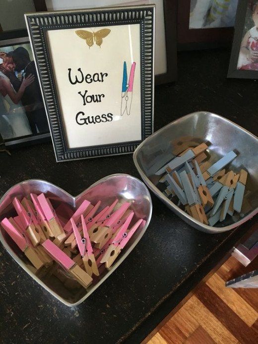 two bowls filled with clothes pins next to a sign that says wear your guess