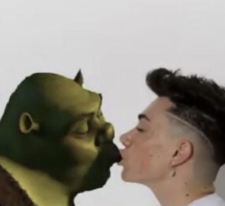 a man with a goatee is kissing another man's face in front of a white background