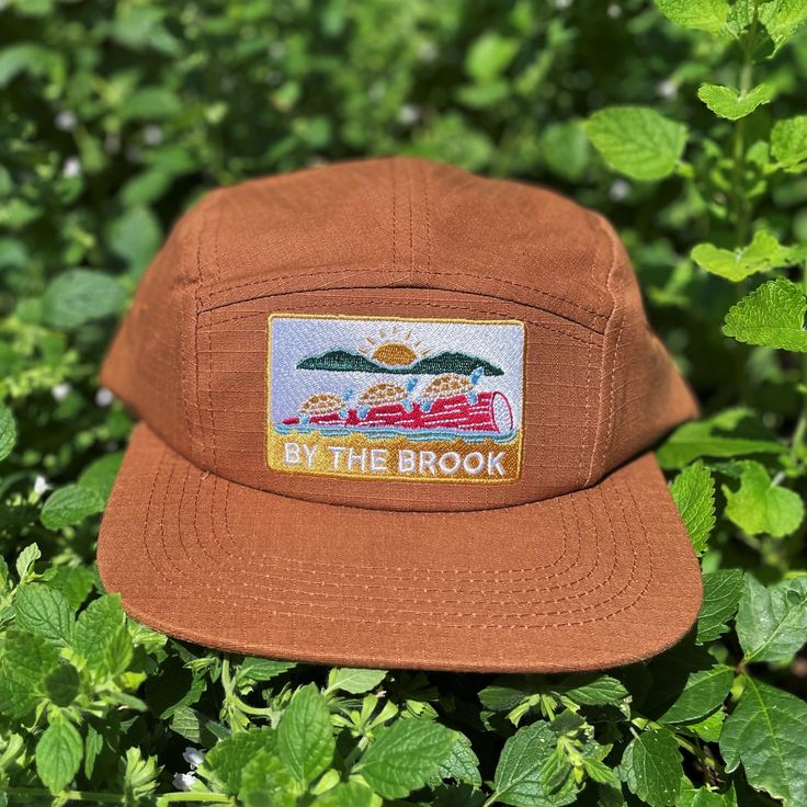 "This \"By The Brook\" flat brim, five panel camper style cap has a turtle and sun embroidered patch and a nylon strap clip closure. Comfortable and classic! * Soft-structured (made of cotton) * Color: Brown Rust * Five panel * Low profile * Nylon strap clip closure * Made by fermentation enthusiasts * The perfect gift for outdoorsy and stylish friends!" Olive Green Hat, Camper Hat, Five Panel Hat, Camping Vintage, Classic Campers, Dinosaur Hat, Hiking Hat, Flat Brim Hat, Camp Style