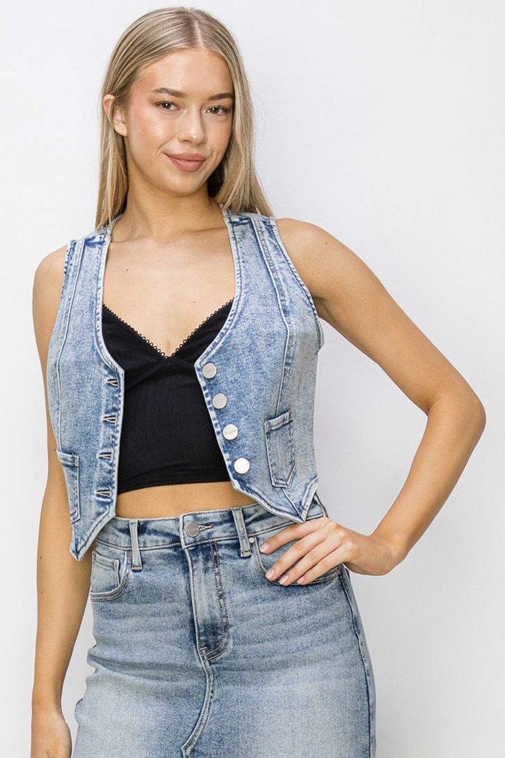 Take your denim game to the next level with the Risen Crop Denim Vest. Featuring a Western style and a length of 18 1/2", this vest is sure to add some edge to your wardrobe. Made with a blend of cotton, polyester, and spandex, this vest offers comfort and style. Size S fits chest sizes 33 1/2" due to its stretchy fabric. Trendy Denim Vest Top For Fall, Trendy Fall Denim Vest Top, Fall Sleeveless Denim Vest Top, Trendy Sleeveless Denim Top For Fall, Fitted Casual Denim Vest Top, Casual Fitted Denim Vest Top, Fitted Tank Top With Pockets For Spring, Fitted Spring Tank Top With Pockets, Trendy Fitted Denim Blue Vest