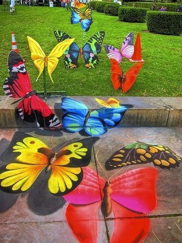 some colorful butterflies are sitting on the ground