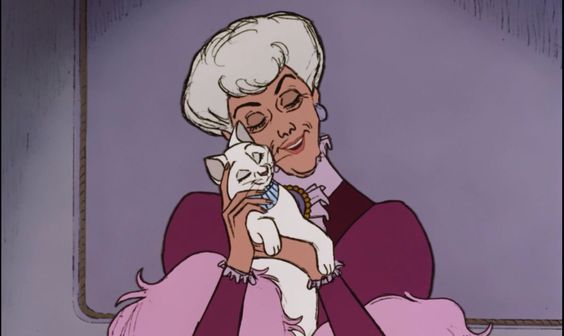 an older woman holding a small dog in her arms