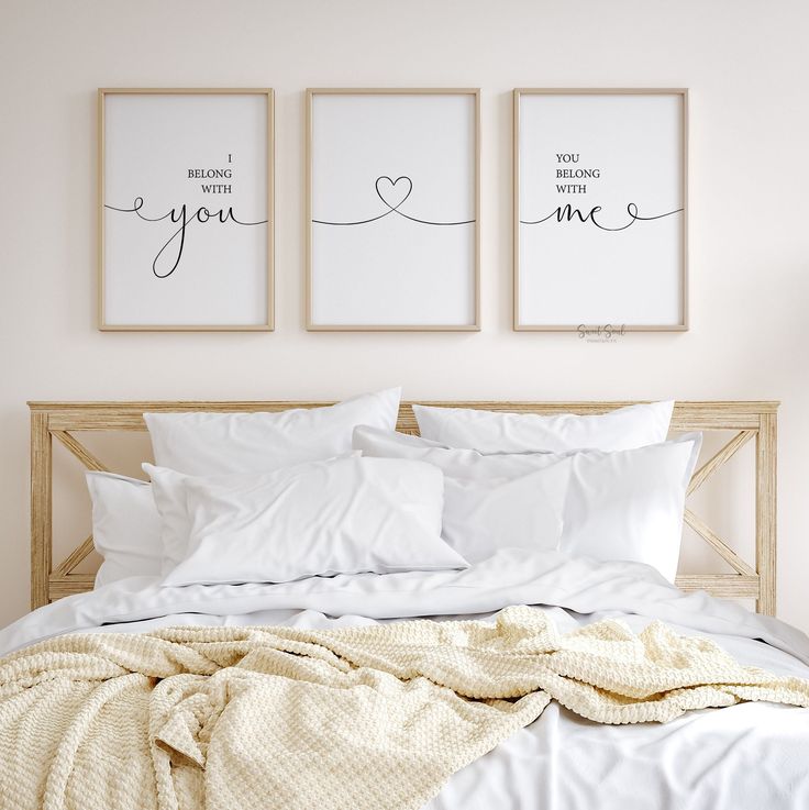 a bed with two framed pictures above it