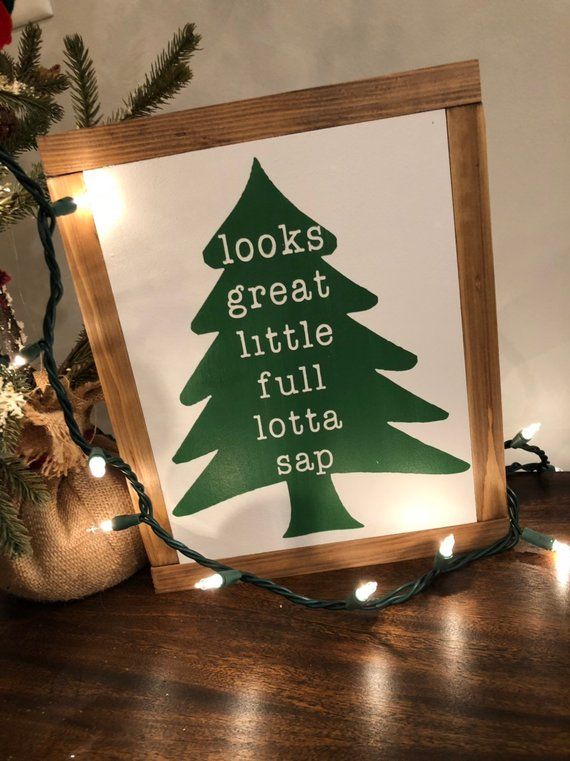 a green christmas tree sign with lights around it and the words looks great, little, full, lotta sap