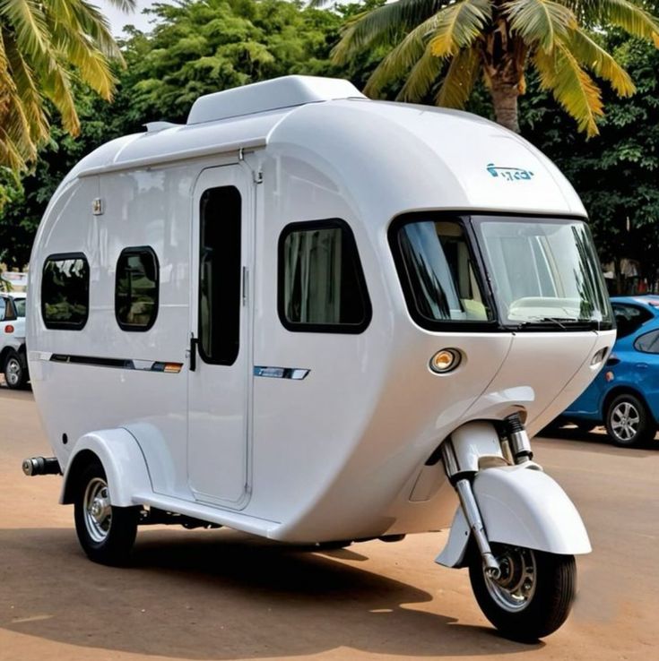 a motor home is parked on the side of the road in front of some palm trees