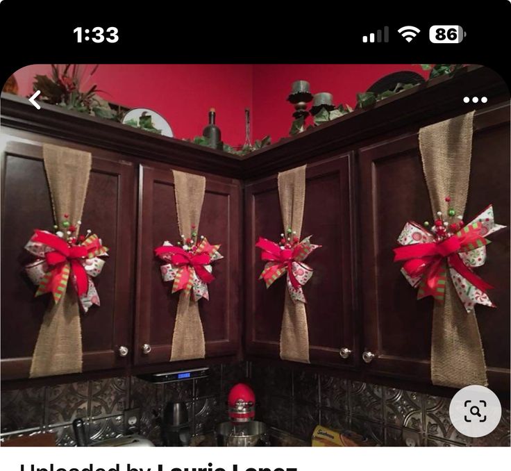 the kitchen cabinets are decorated with red bows