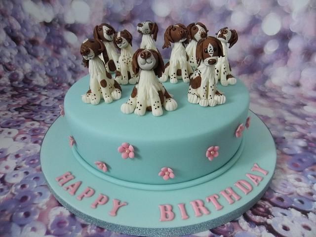 a birthday cake with dogs on top