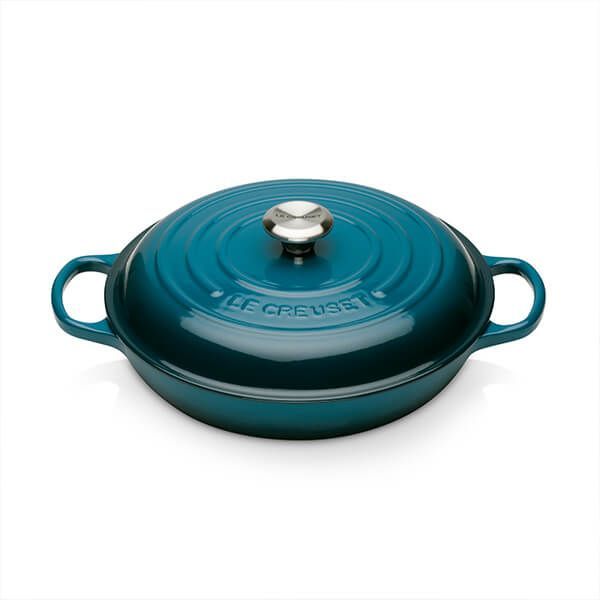 a blue cast iron casserole on a white background