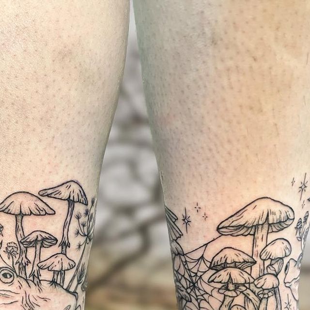 the legs are covered in tattoos with mushrooms and stars on them as if they were from fairy tales