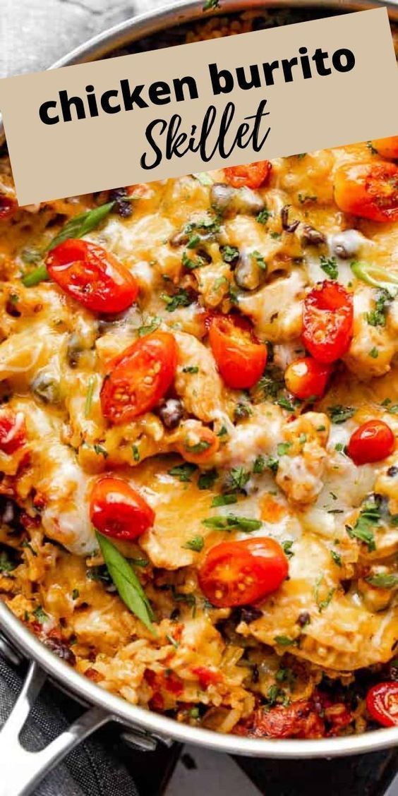 chicken burrito skillet with tomatoes and cheese in a pan on top of a table