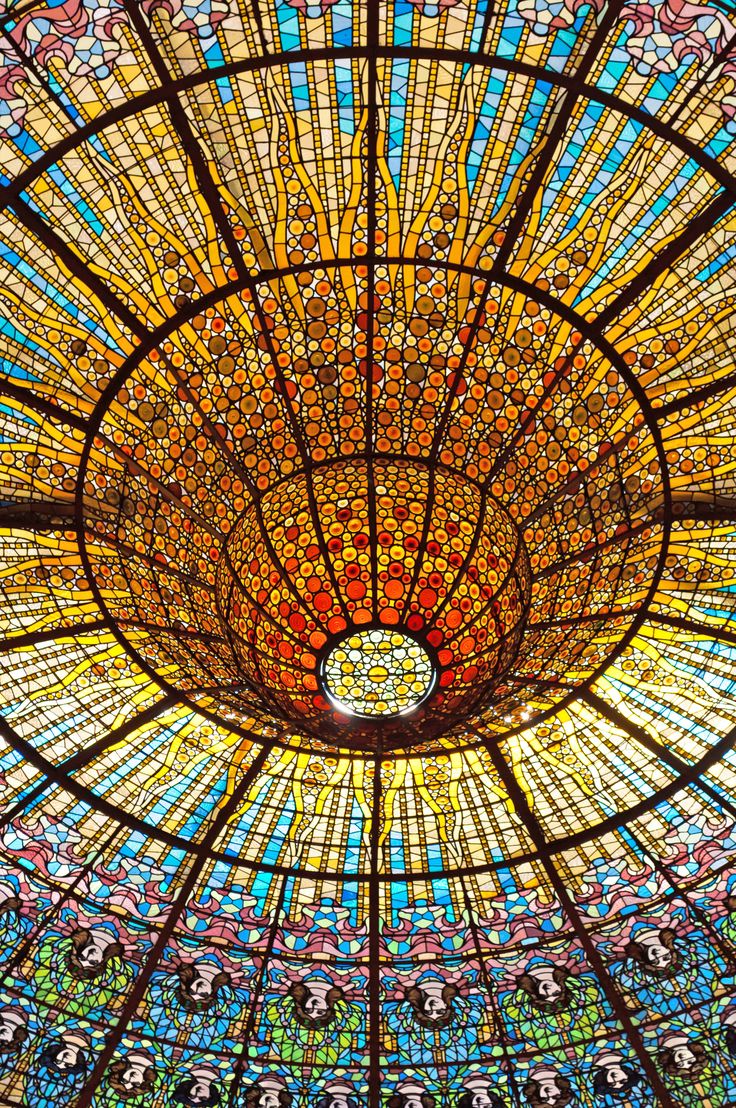 the inside of a glass dome with many different colors and designs on it's ceiling