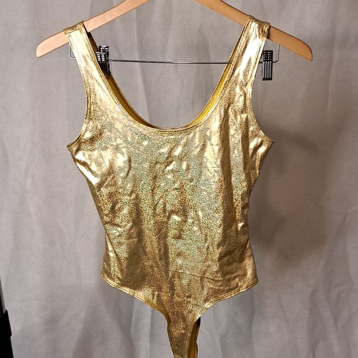 This Metallic Gold Bodysuit Is For Fashion And Not A Swimsuit Rounded At The Top And Seems To Be Kinda High Sides At The Bottom And You Could Wear Them With Low Rise Jeans 96% Polyester 4% Spandex Gold Body Suits, Metallic Stretch Sleeveless Bodysuit, Metallic Sleeveless Stretch Bodysuit, Gold Stretch Bodysuit For Summer, Metallic Sleeveless Fitted Bodysuit, Metallic Fitted Sleeveless Bodysuit, Gold Fitted Bodysuit For Club, Gold Stretch Sleeveless Bodysuit, Sleeveless Lined Body Leotard For Party