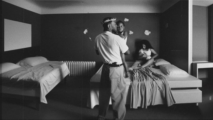 a man standing next to a woman in a bedroom