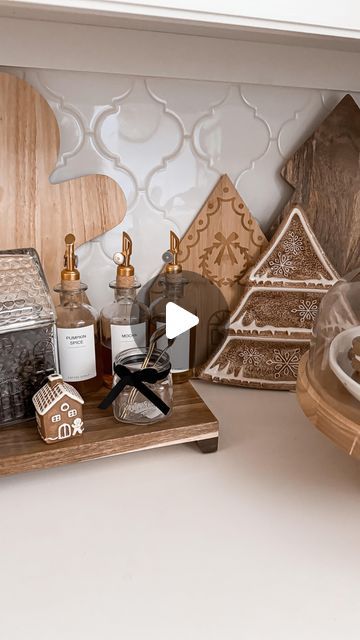 a wooden tray topped with lots of different types of items next to a wall mounted clock