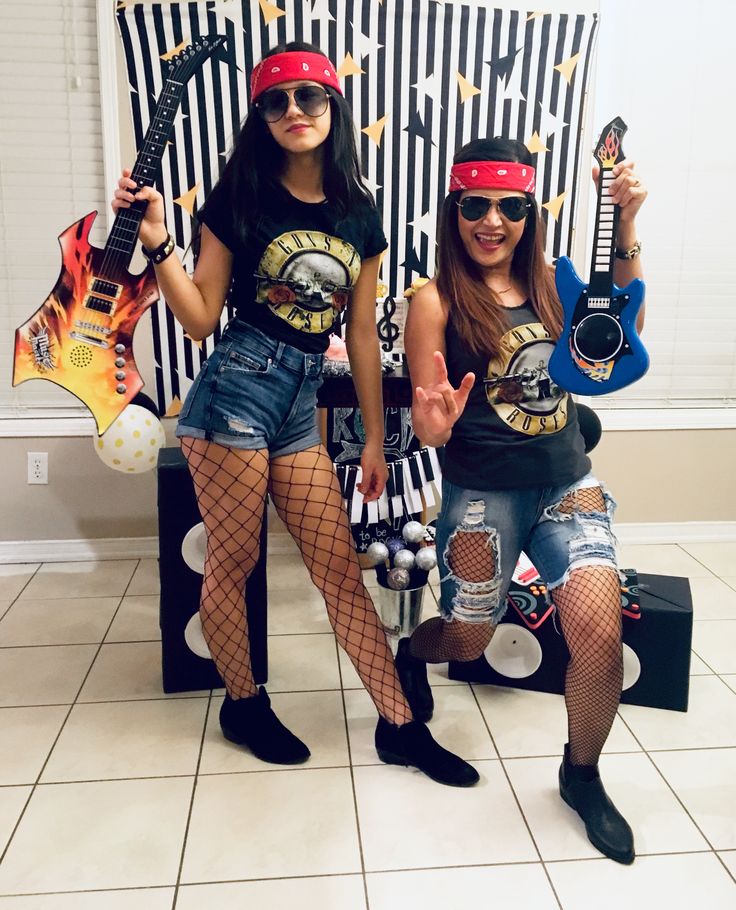 two women dressed up in costumes and holding guitars