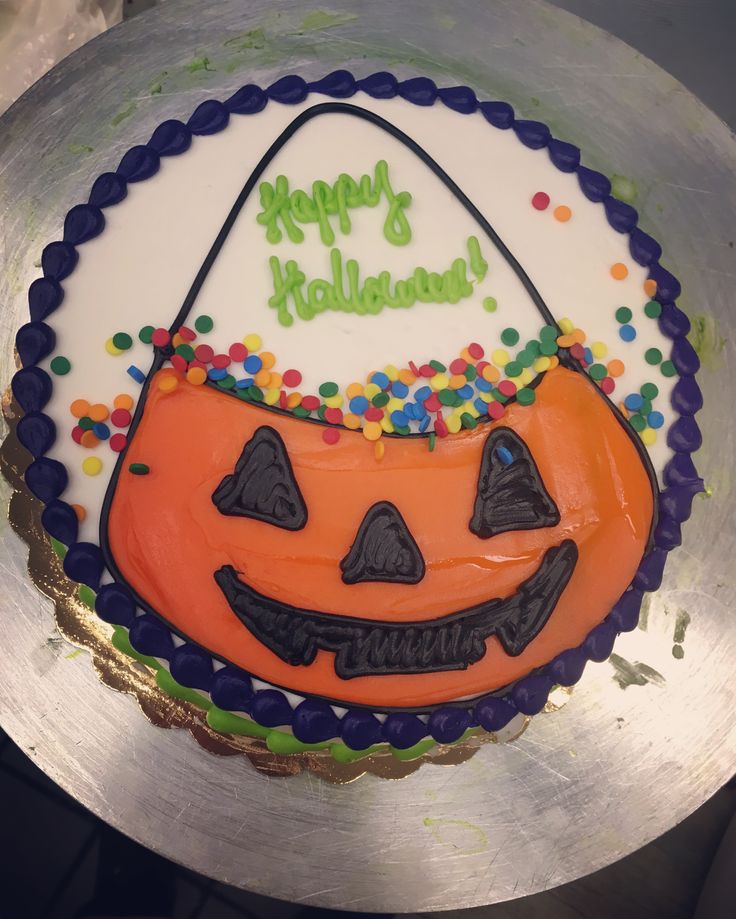 a birthday cake decorated to look like a pumpkin with happy halloween written on the side