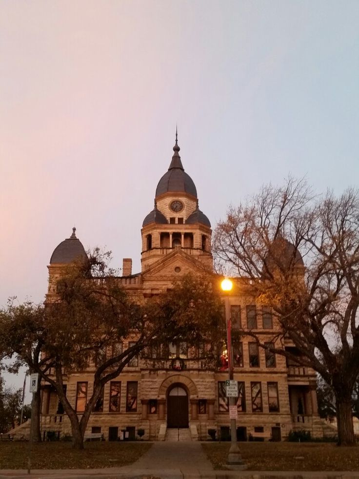 an old building with a clock tower at dusk