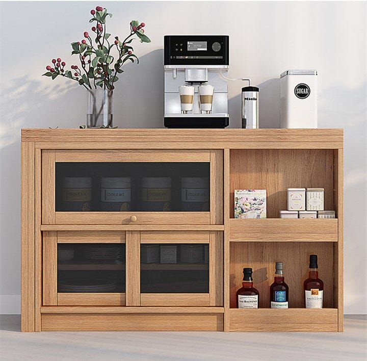 a wooden shelf with bottles and cups on it in front of a coffee maker, microwave and other items