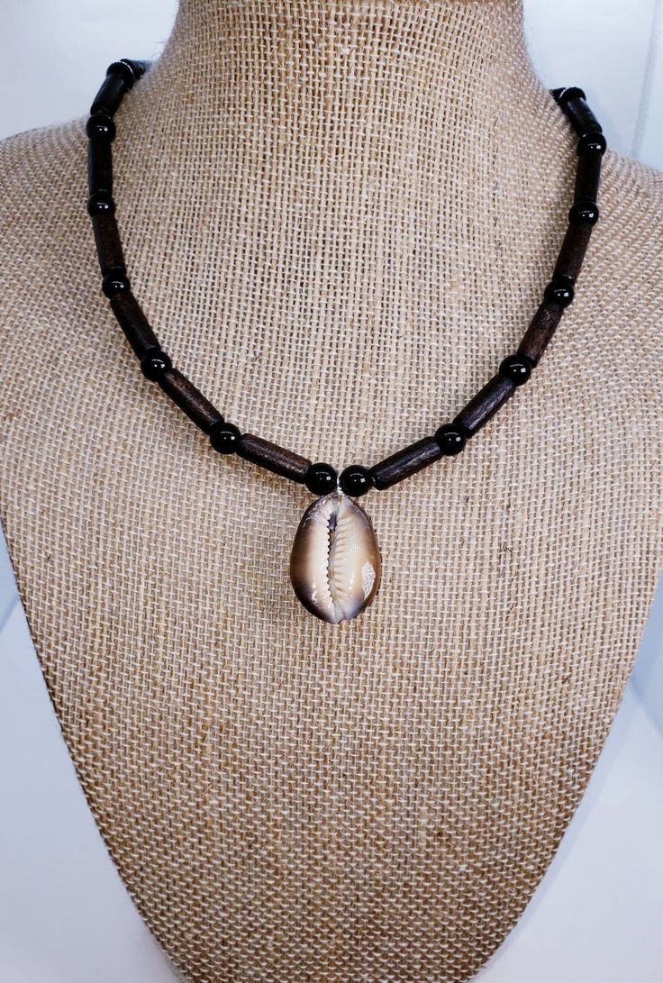 Please tap the link below to view my other BOHO jewelry products. www.etsy.com/shop/transcendenceboho COWRIE SHELL NECKLACE ITEM DETAILS This necklace has a touch of fun and class for those who want to make a simple statement.  The wood tube beads, black glass beads and tiger cowrie shell pendant speak for themselves.  This is suitable for males and females; children and adults.   NECKLACE LENGTH = 17 inches; length adjustable if requested.  NOTE:   Gift bag included.  All necklace lengths are a Vsco Jewelry, Tiger Cowrie Shell, Mens Choker Necklace, Beach Hippie, Hawaiian Necklace, Seashell Bracelet, Cowrie Shell Necklace, Caribbean Beach, Shell Choker