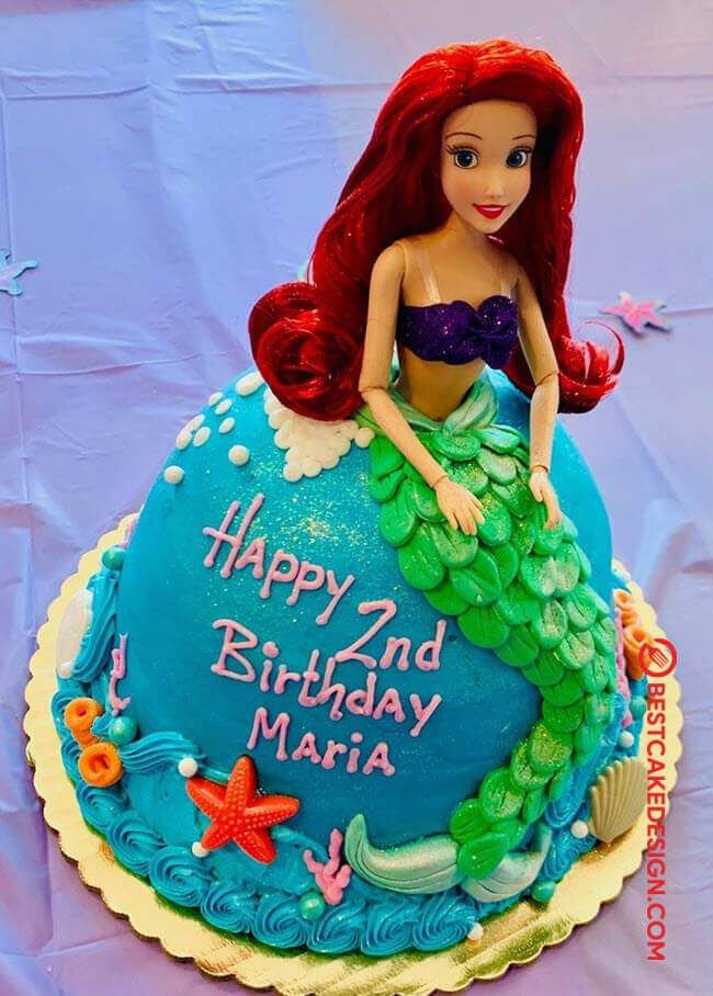 a birthday cake with a little mermaid on it