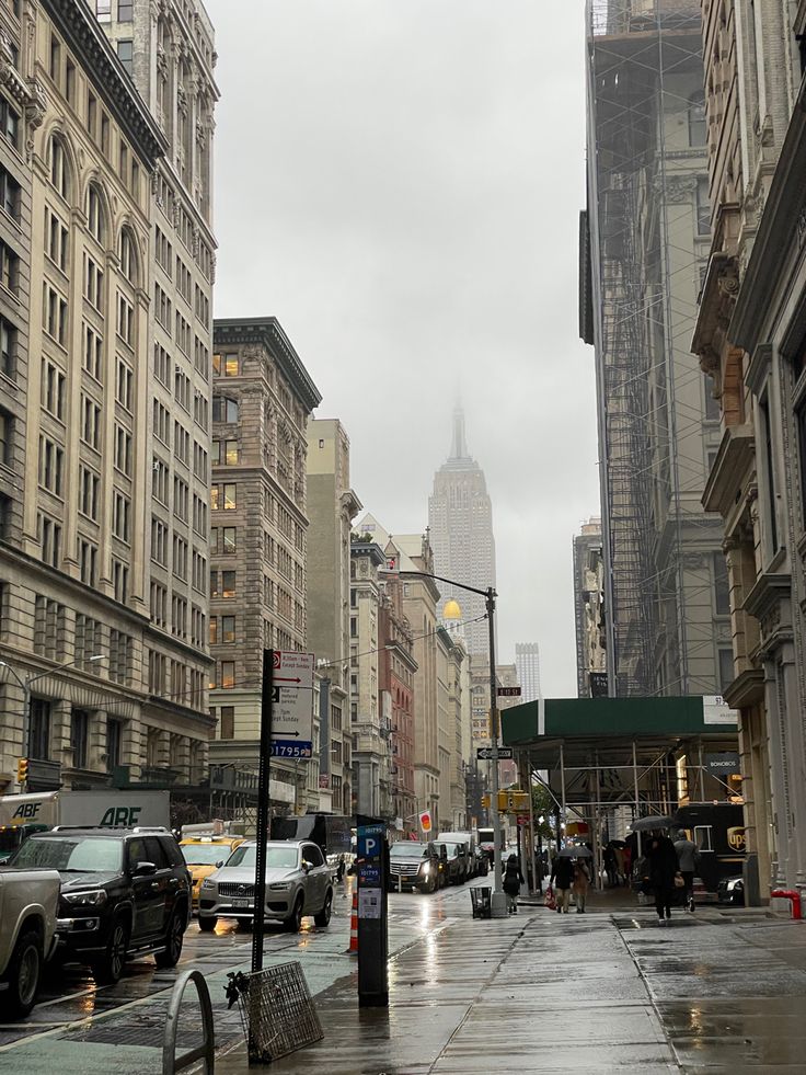 an empty city street with cars parked on the side