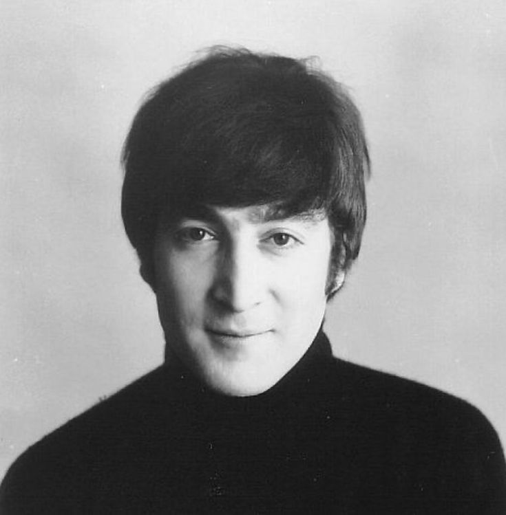 a black and white photo of a man with short hair wearing a turtle neck sweater