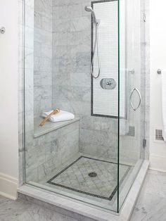 a walk in shower sitting inside of a bathroom