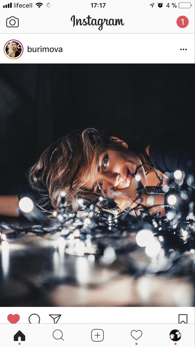 a woman laying on top of a table covered in christmas lights with the caption instagram