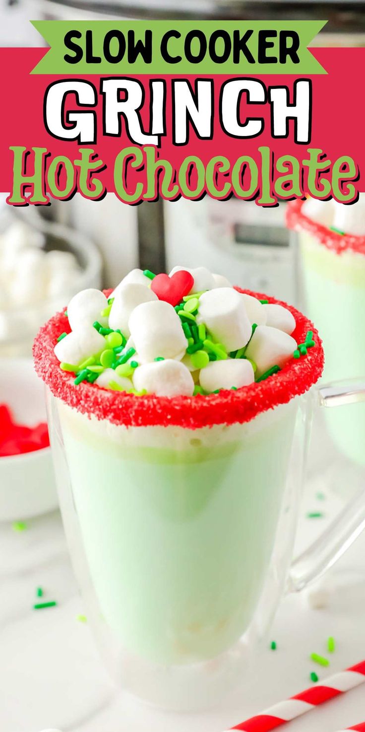 a green drink with marshmallows and candy in it, sitting on a table