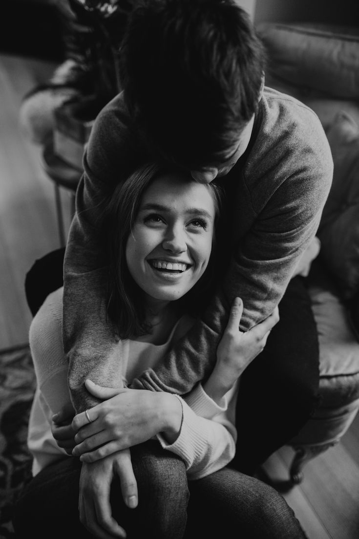 black and white photograph of a man hugging a woman