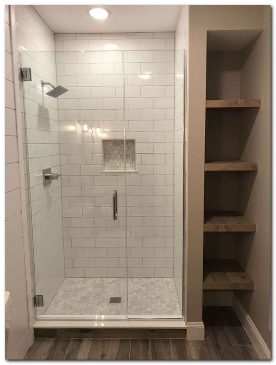 a walk in shower sitting inside of a bathroom