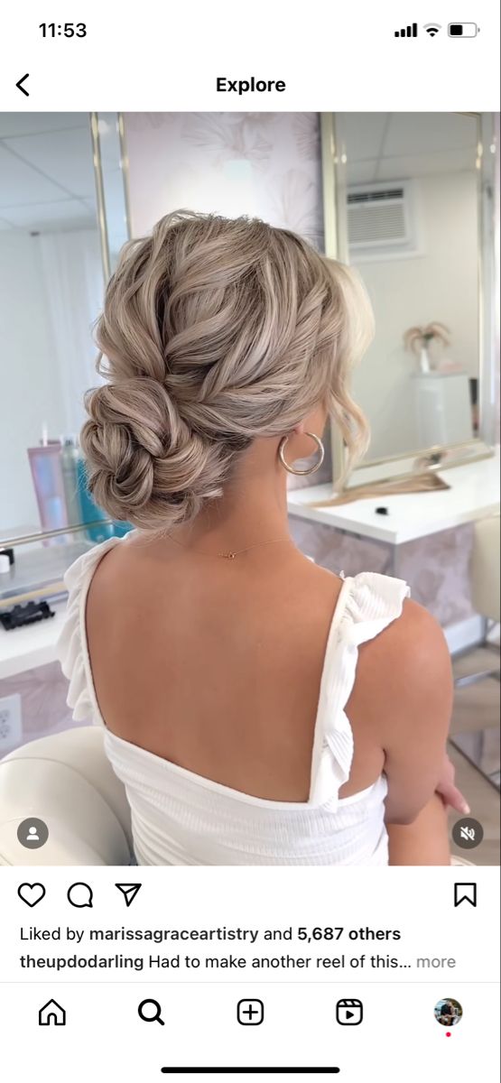 the back of a woman's head with her hair styled into a low bun