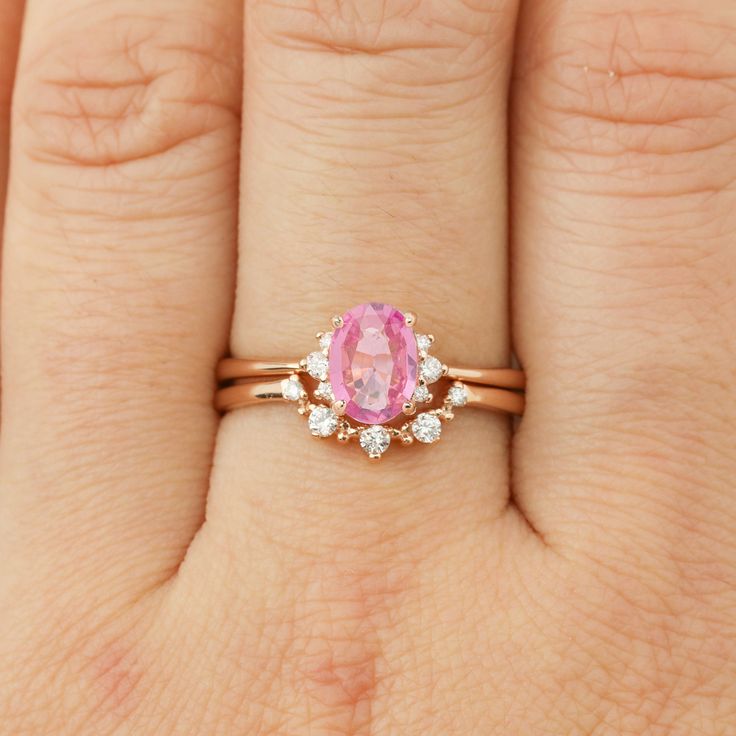 One of a kind ring Pink sapphire, 0.7ct., 6.79mm 0.04ctw G color SI clarity white accent diamonds Band width x height: approx. 1.5mm x 1.6mm Low profile, classic four-prong basket setting Made of 100% recycled solid 14k rose gold and ethically sourced gemstones Custom Order This ring is offered in other sizes, metal, and the center stone can be upgraded/downgraded to suit your preference. These requests can be accommodated as Semi-Custom Order. Click here to learn more about this service. About Rose Gold Pink Sapphire Ring For Wedding, Rose Gold Pink Sapphire Wedding Ring, Wedding Rose Gold Pink Sapphire Ring, Oval Pink Sapphire Ring In Rose Gold, Oval Rose Gold Pink Sapphire Ring, Rose Gold Oval Pink Sapphire Ring, Pink Sapphire Engagement Ring, Profile Classic, Pink Sapphire Ring Engagement