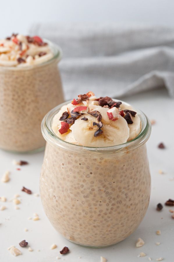 two jars filled with oatmeal and topped with banana slices