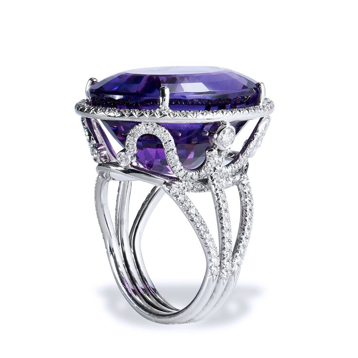 Crafted in 18kt white gold, this ring features a 22.70ct Amethyst center gemstone. The Amethyst is showcased in a beautifully ornate setting that features .75ct of H-VS graded pave set diamonds. SKU: 07287 Luxury Platinum Amethyst Ring In Silver, Luxury White Gold Amethyst Ring With Gemstone Accents, Luxury Amethyst Ring With Prong Setting, Luxury White Gold Amethyst Ring, Luxury White Gold Amethyst Ring With Halo Setting, Luxury Amethyst Ring With Halo Setting, Luxury Oval Amethyst Platinum Ring, Luxury Purple Platinum Rings, Luxury White Gold Amethyst Ring With Diamond Accents